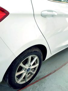 a white car with a repaired rear offside wheel arch